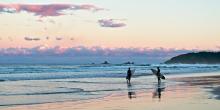 Two surfers at Suffolk Park Beach, Byron Bay.